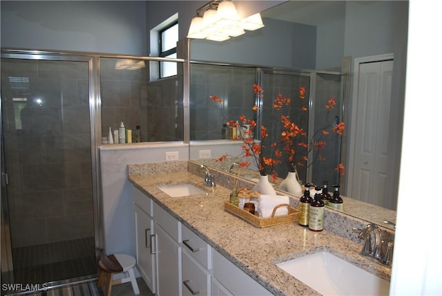 bathroom with vanity and a shower with door