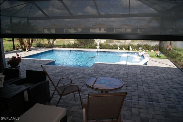 view of pool with a lanai and a patio area