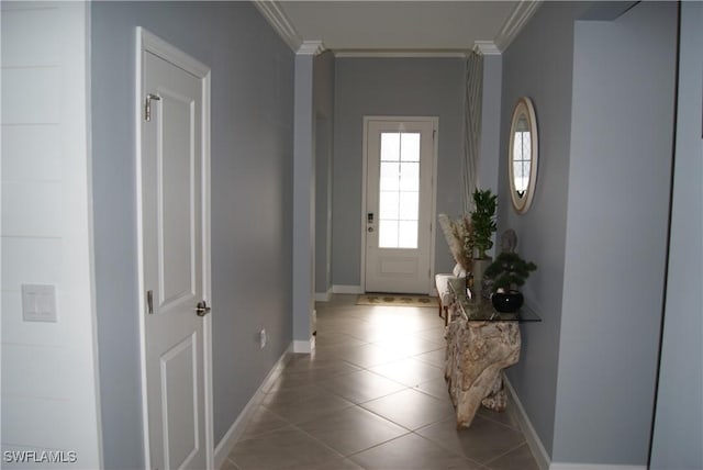 doorway with ornamental molding and light tile patterned floors