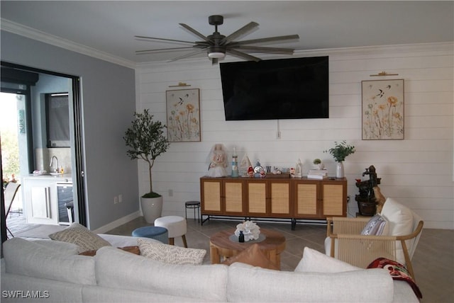 tiled living room featuring ornamental molding, sink, and ceiling fan