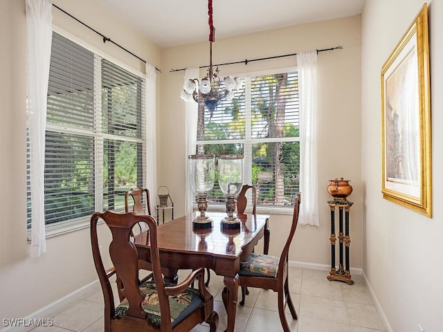 dining area with light tile patterned floors and a notable chandelier