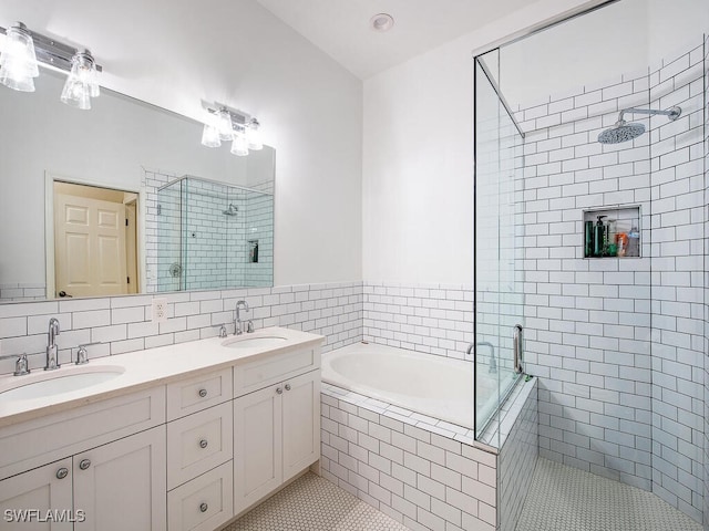 bathroom featuring vanity, decorative backsplash, and independent shower and bath