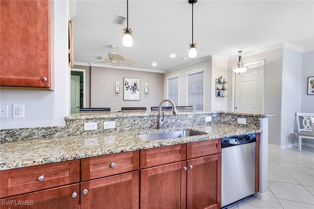 kitchen featuring light stone counters, dishwasher, sink, and pendant lighting