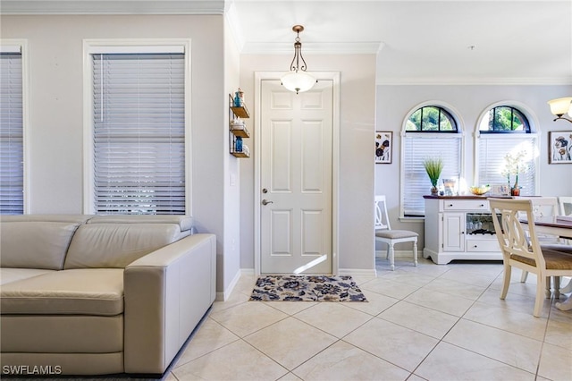 entryway with crown molding and light tile patterned floors