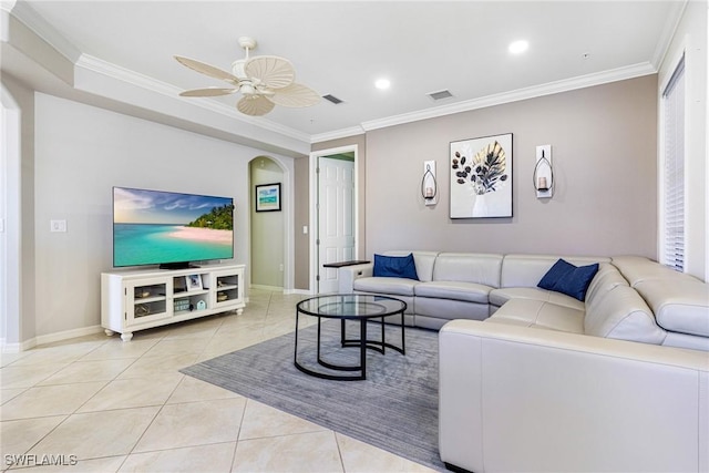 tiled living room featuring ceiling fan and ornamental molding