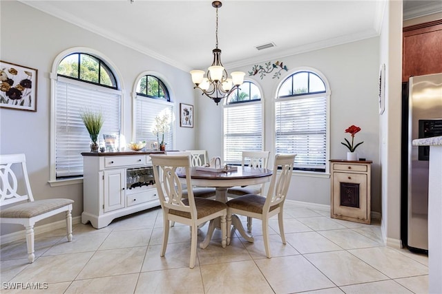 dining area with light tile patterned floors, plenty of natural light, and a chandelier