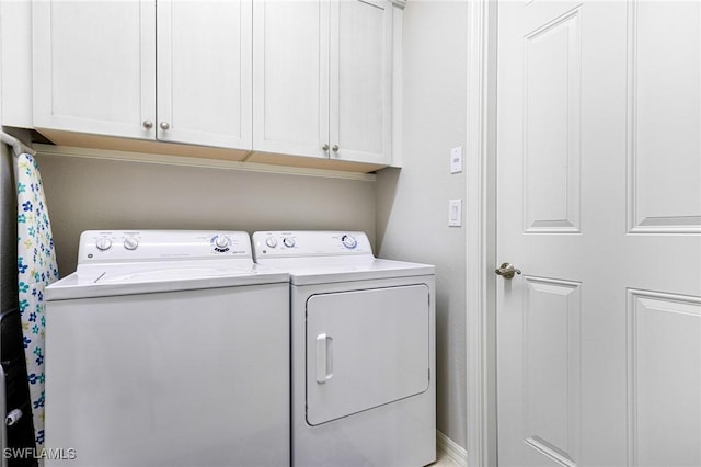 laundry room with cabinets and independent washer and dryer