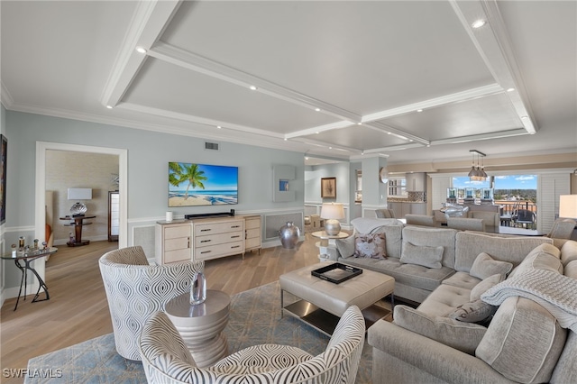 living room featuring beamed ceiling, ornamental molding, coffered ceiling, and light hardwood / wood-style flooring