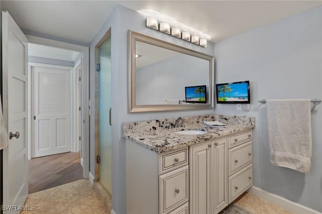 bathroom with vanity, tile patterned floors, and walk in shower