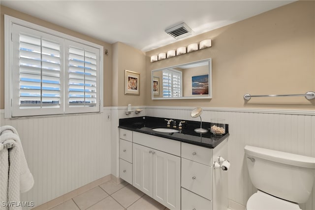 bathroom with vanity, tile patterned floors, and toilet