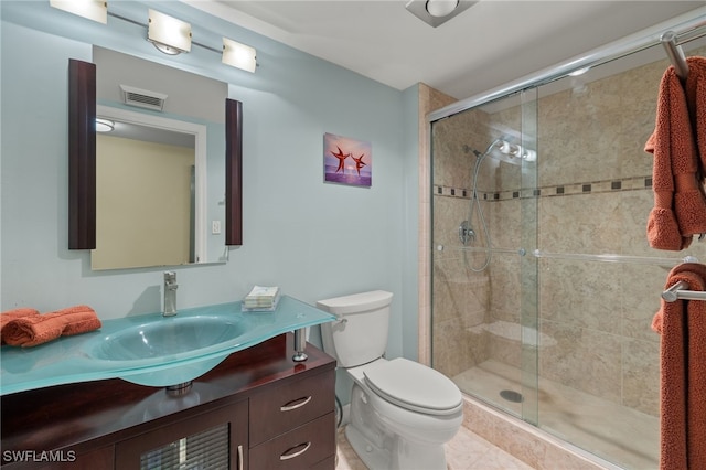 bathroom with an enclosed shower, vanity, and toilet