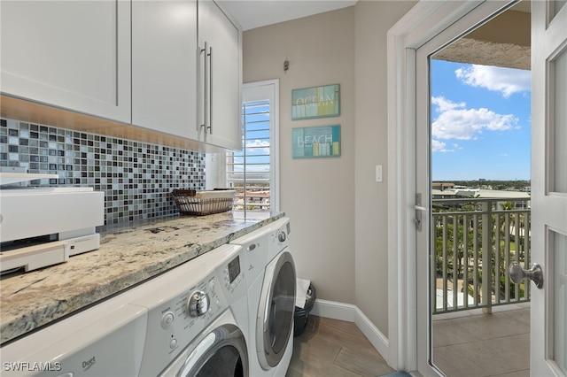 laundry room with independent washer and dryer, cabinets, and a healthy amount of sunlight