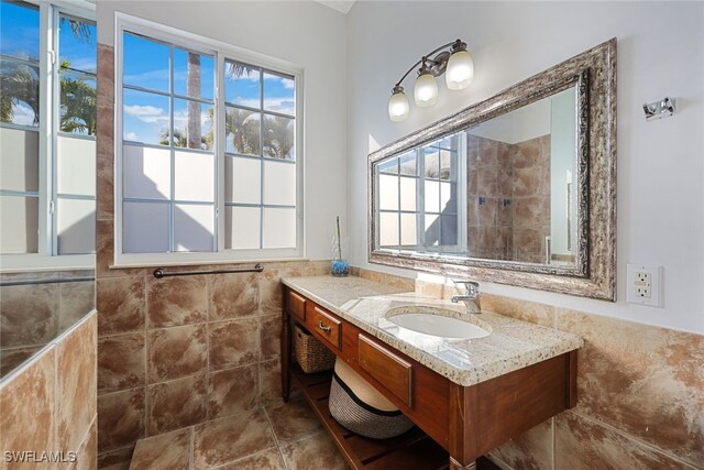 646 111th Ave N, Naples, FL 34108 - full bath with tile walls, vanity, and a wainscoted wall