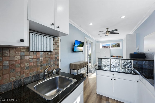 646 111th Ave N, Naples, FL 34108 - kitchen featuring dark countertops, ornamental molding, ceiling fan, backsplash, and white cabinetry
