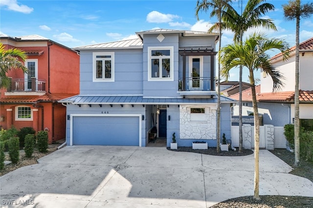 view of front of property featuring a garage and a balcony