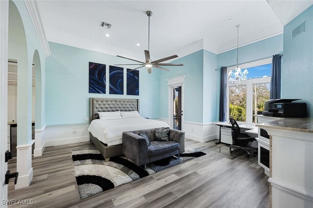 646 111th Ave N, Naples, FL 34108 - bedroom featuring wood finished floors, arched walkways, wainscoting, recessed lighting, and a chandelier