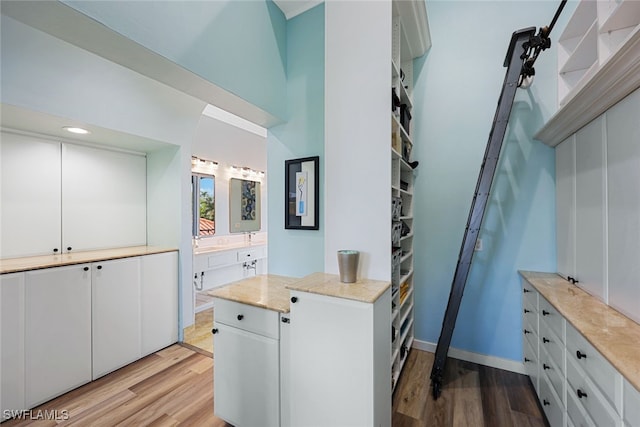 646 111th Ave N, Naples, FL 34108 - bathroom with wood finished floors, vanity, and recessed lighting
