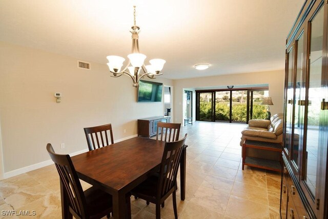 dining space with a notable chandelier