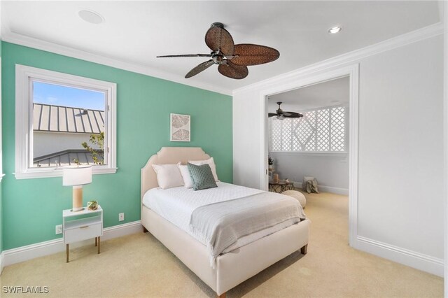 bedroom with a ceiling fan, baseboards, ornamental molding, and carpet flooring