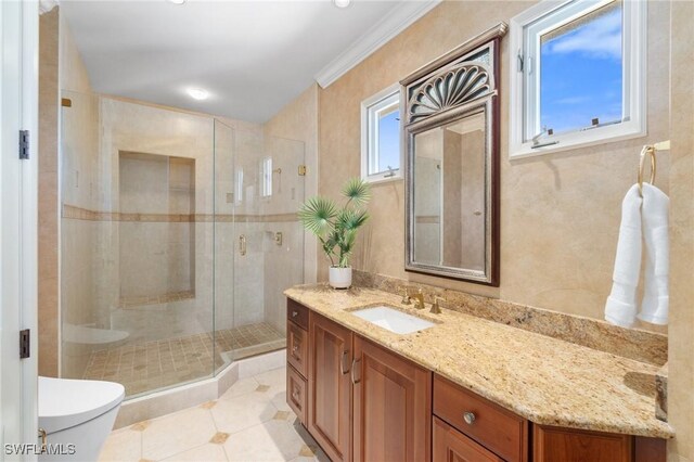 full bath with toilet, ornamental molding, tile patterned floors, vanity, and a shower stall