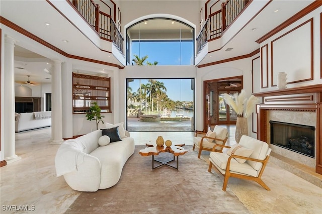 interior space with a high end fireplace and ornate columns