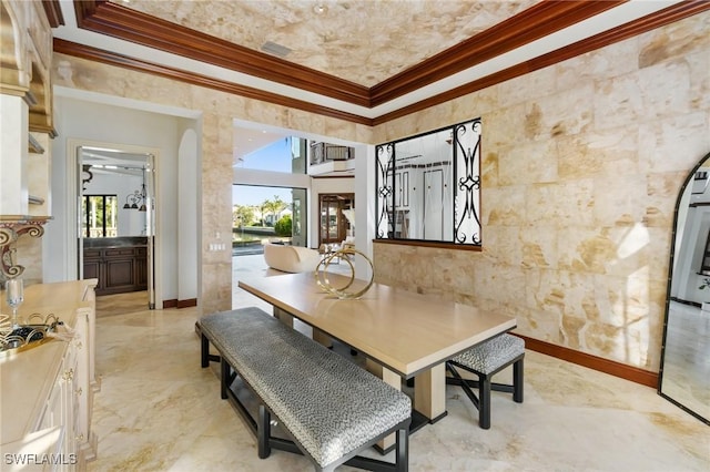 dining area with marble finish floor, ornamental molding, plenty of natural light, and baseboards