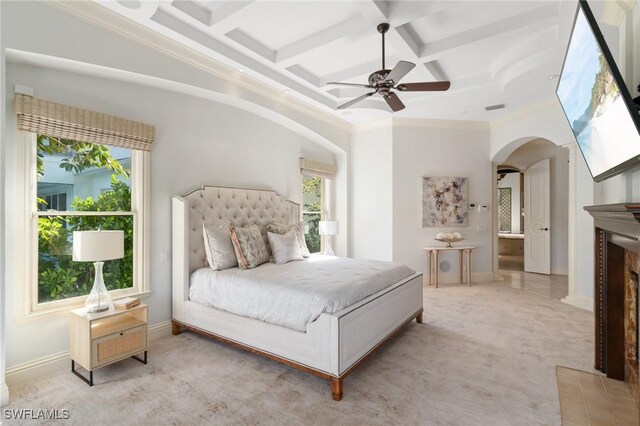 bedroom featuring arched walkways, crown molding, light carpet, coffered ceiling, and baseboards