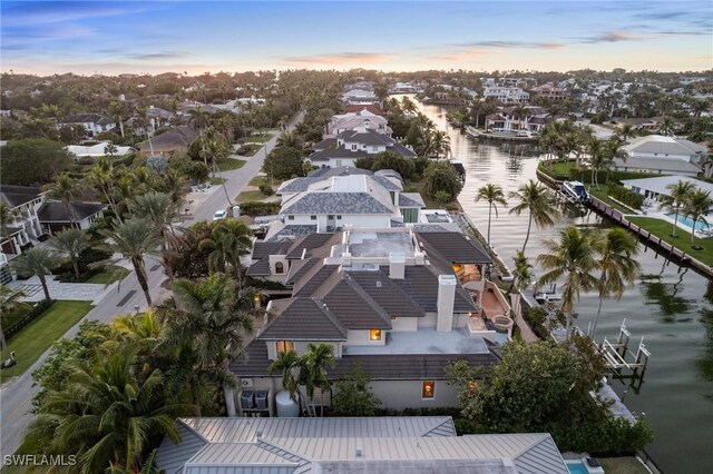 drone / aerial view featuring a residential view and a water view