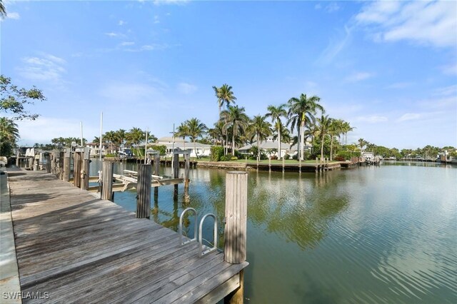 dock area with a water view and boat lift