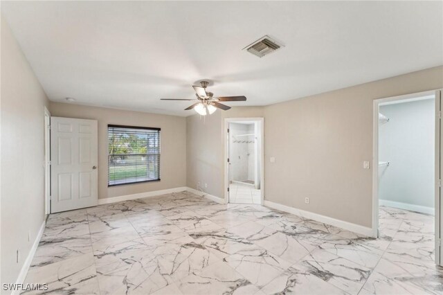 unfurnished room with ceiling fan