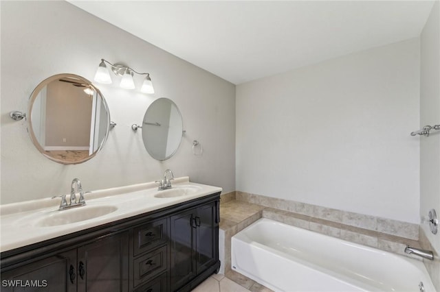 bathroom featuring tile patterned floors, a tub to relax in, and vanity