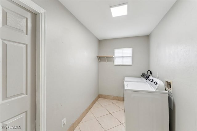 washroom with independent washer and dryer and light tile patterned flooring