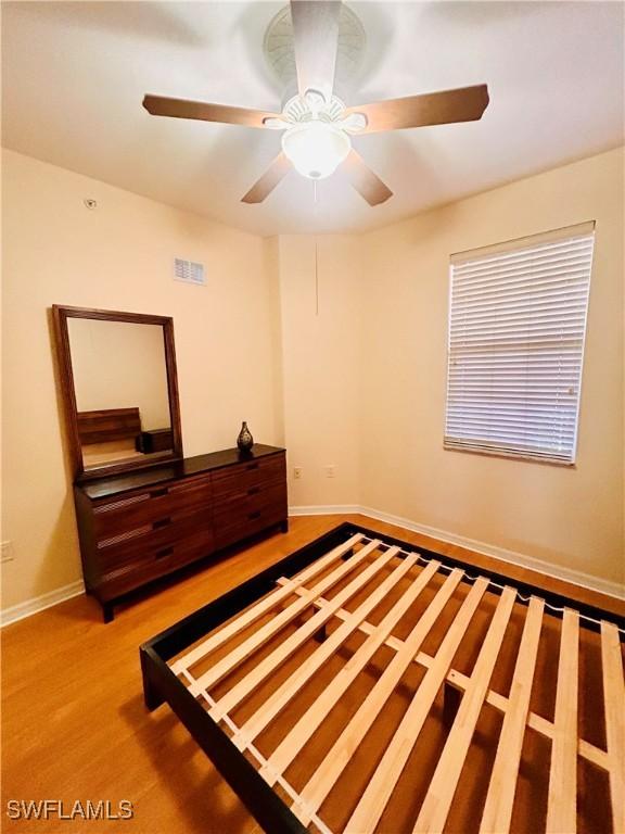 unfurnished bedroom with hardwood / wood-style flooring and ceiling fan