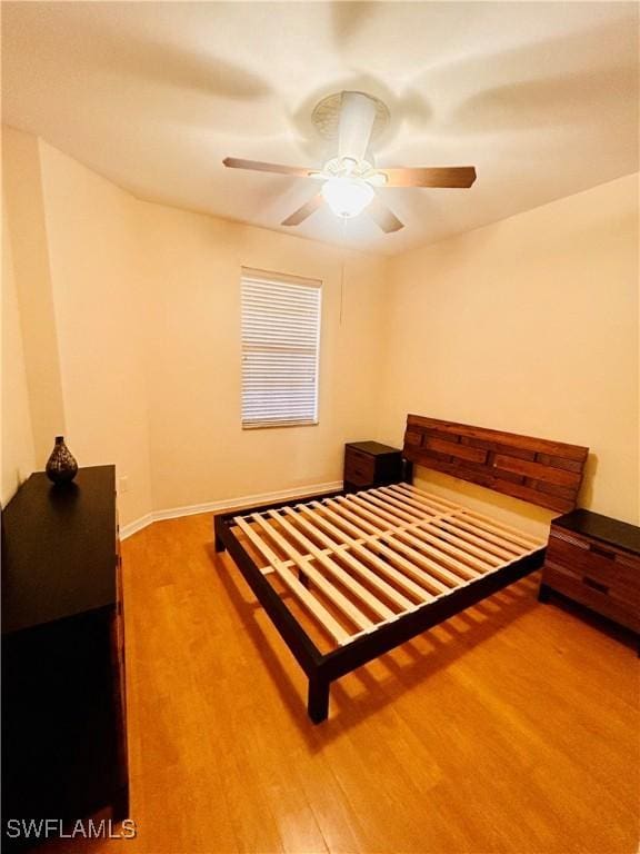 bedroom with hardwood / wood-style flooring and ceiling fan