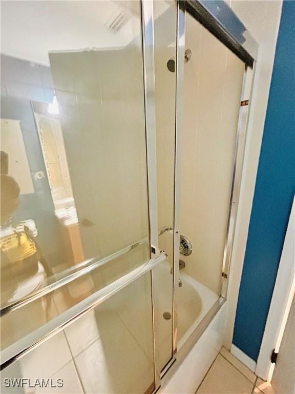 bathroom featuring enclosed tub / shower combo and tile patterned floors