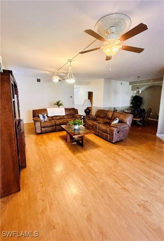 living room featuring ceiling fan and light wood-type flooring