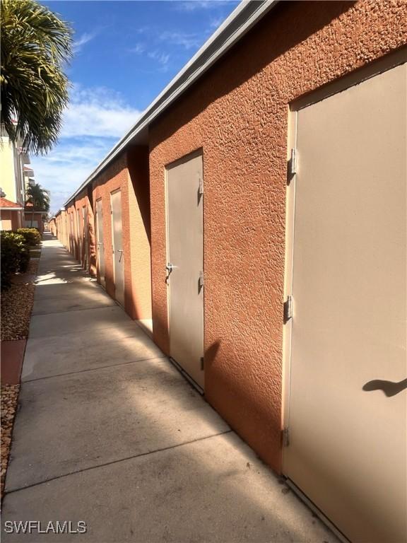 view of side of property featuring fence and stucco siding