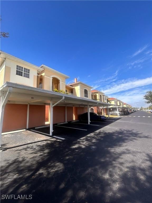 covered parking lot with a residential view