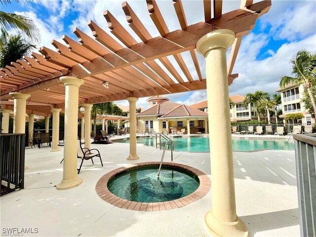 view of pool featuring a hot tub, a patio area, and a pergola