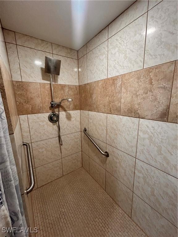 bathroom with tiled shower