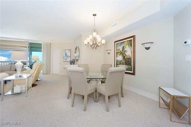 dining room with light carpet, ornamental molding, and a chandelier