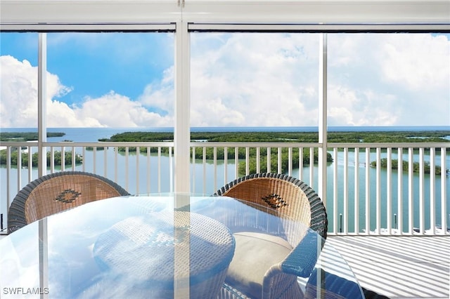 sunroom / solarium featuring a water view and a wealth of natural light