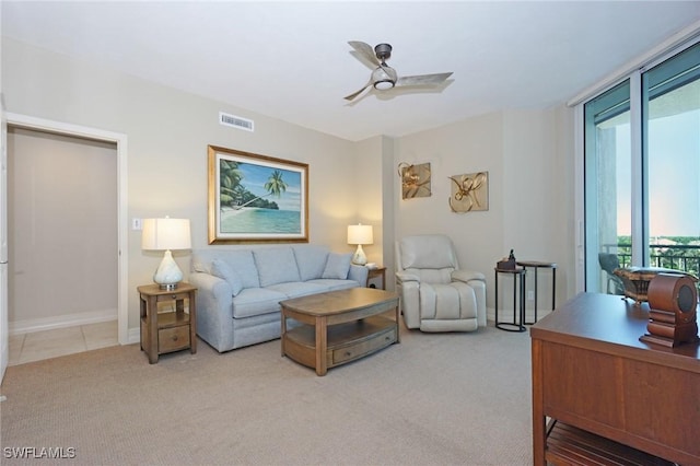 living room with ceiling fan and light carpet