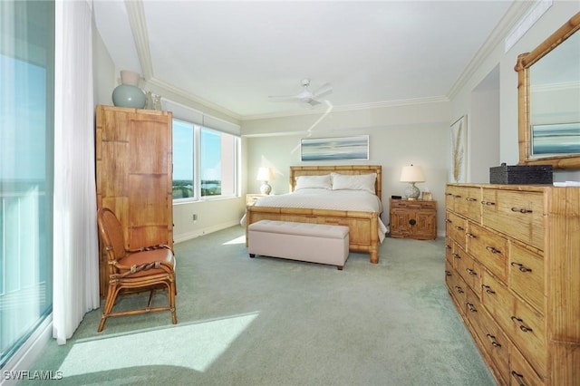 carpeted bedroom featuring ceiling fan and ornamental molding