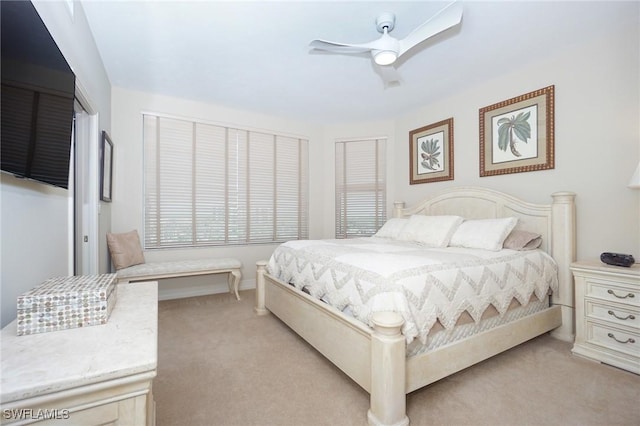 bedroom featuring light carpet and ceiling fan