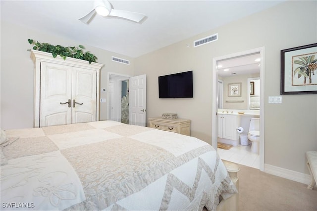 bedroom featuring ceiling fan, ensuite bath, and a closet