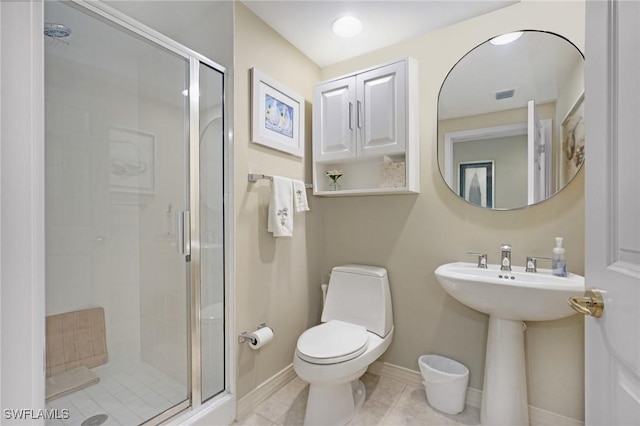 bathroom with sink, toilet, an enclosed shower, and tile patterned flooring