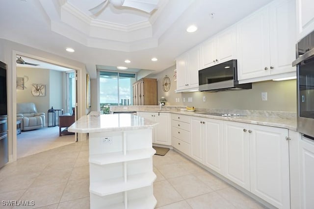 kitchen with white cabinetry, ornamental molding, a raised ceiling, ceiling fan, and black electric stovetop