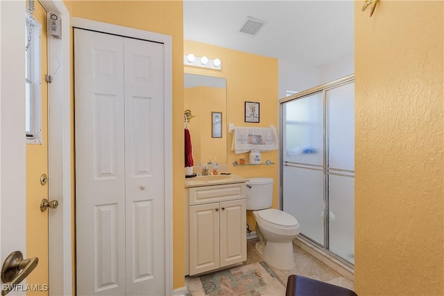 bathroom featuring vanity, an enclosed shower, a healthy amount of sunlight, and toilet