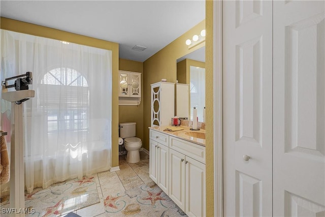 bathroom featuring vanity and toilet